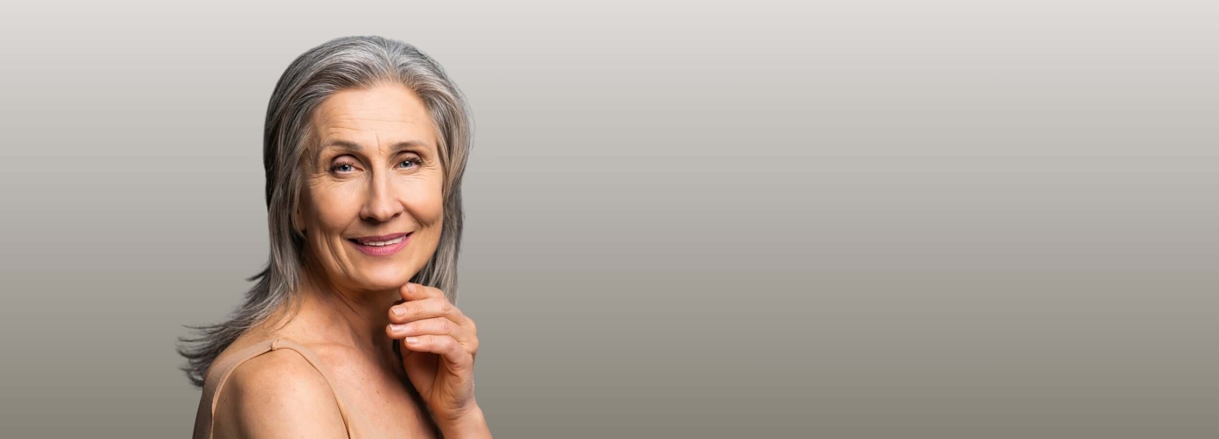 Alt Tag: How Do I Get Rid of Lip Lines? Mature woman smiling, close-up portrait highlighting fine lines around lips and mouth area
