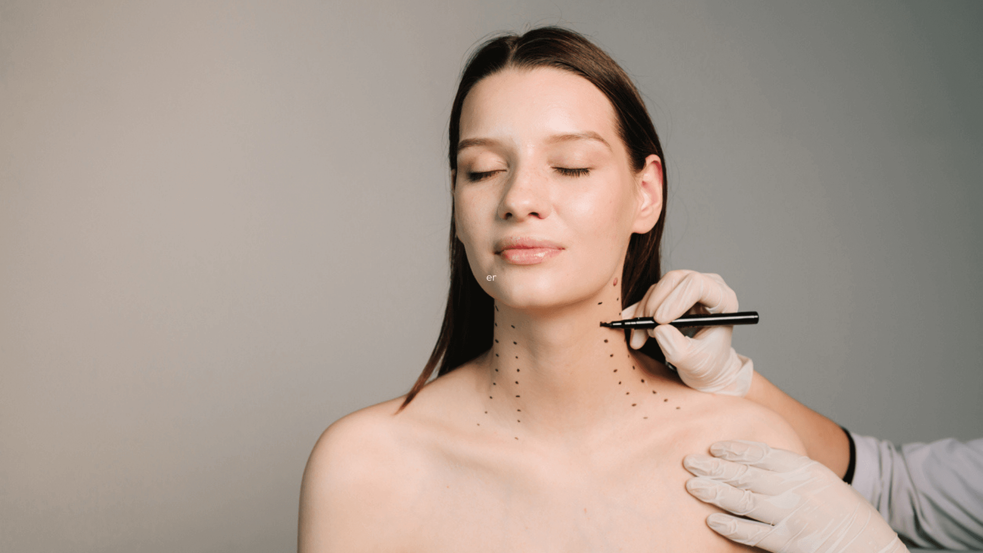 Comparing Botox and Traditional Neck Lifts: clinician marks injection points on woman’s neck before Botox treatment for neck rejuvenation
