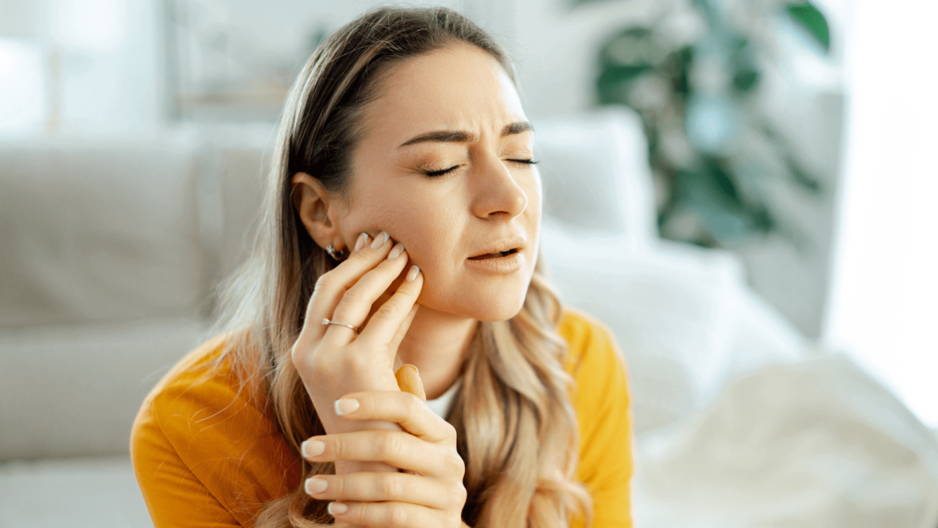 Can Botox in Masseter Lead to Jowls? | Merrion Medical Aesthetics - woman holding jaw, masseter tension and facial contour concerns