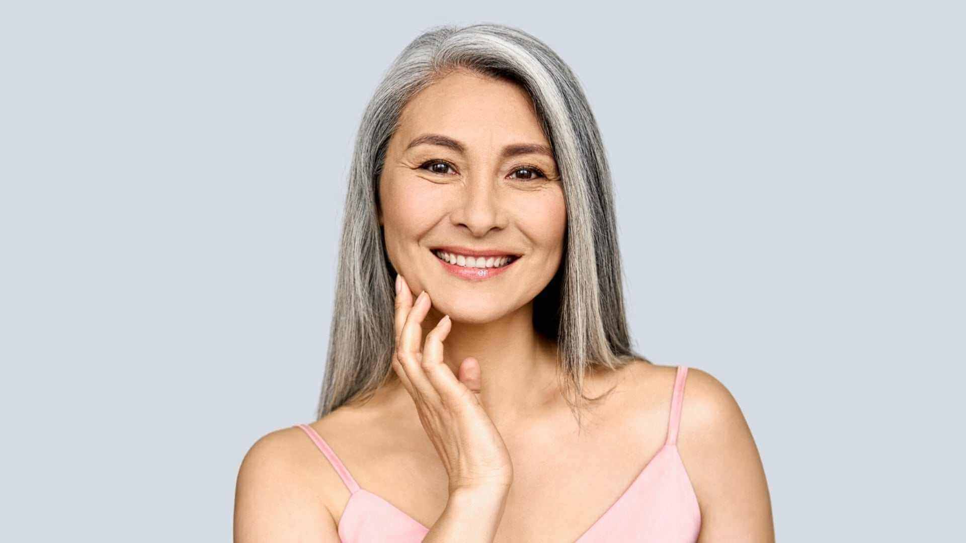 Loose Skin After Weight Loss: Best Skin Tightening Treatments smiling woman touching face, skincare concept for improved firmness
