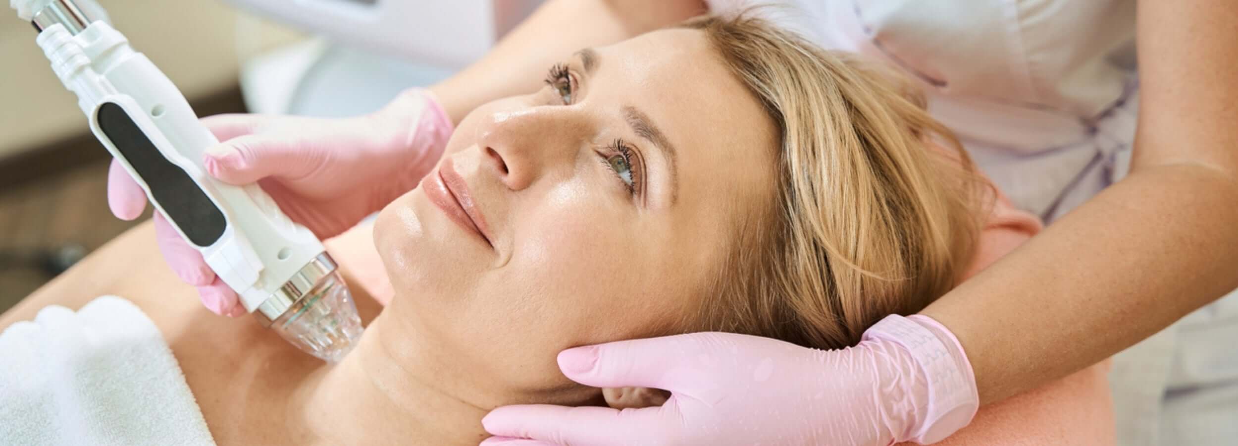 Alt Tag: Understanding the Cost of CO2 Laser Treatment with clinician performing facial laser resurfacing on patient in aesthetic clinic