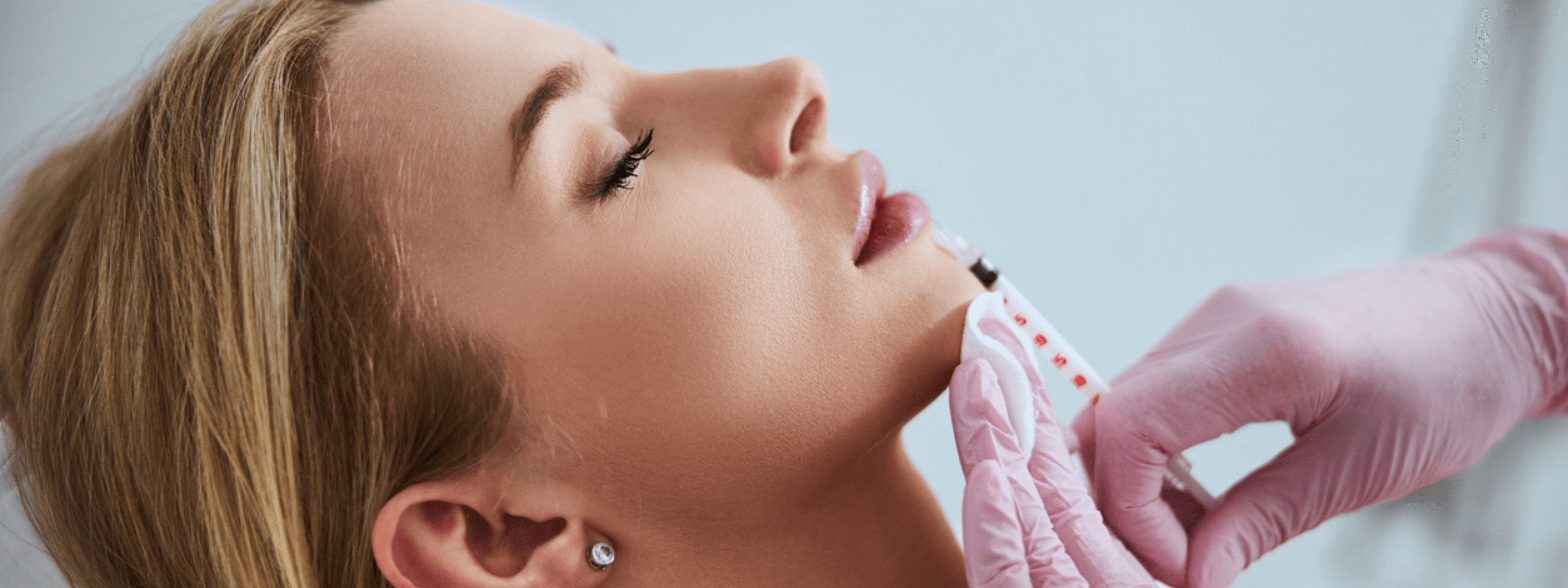 Facial Fillers near me: top Local Clinics consultation with injector assessing woman’s chin for facial filler treatment
