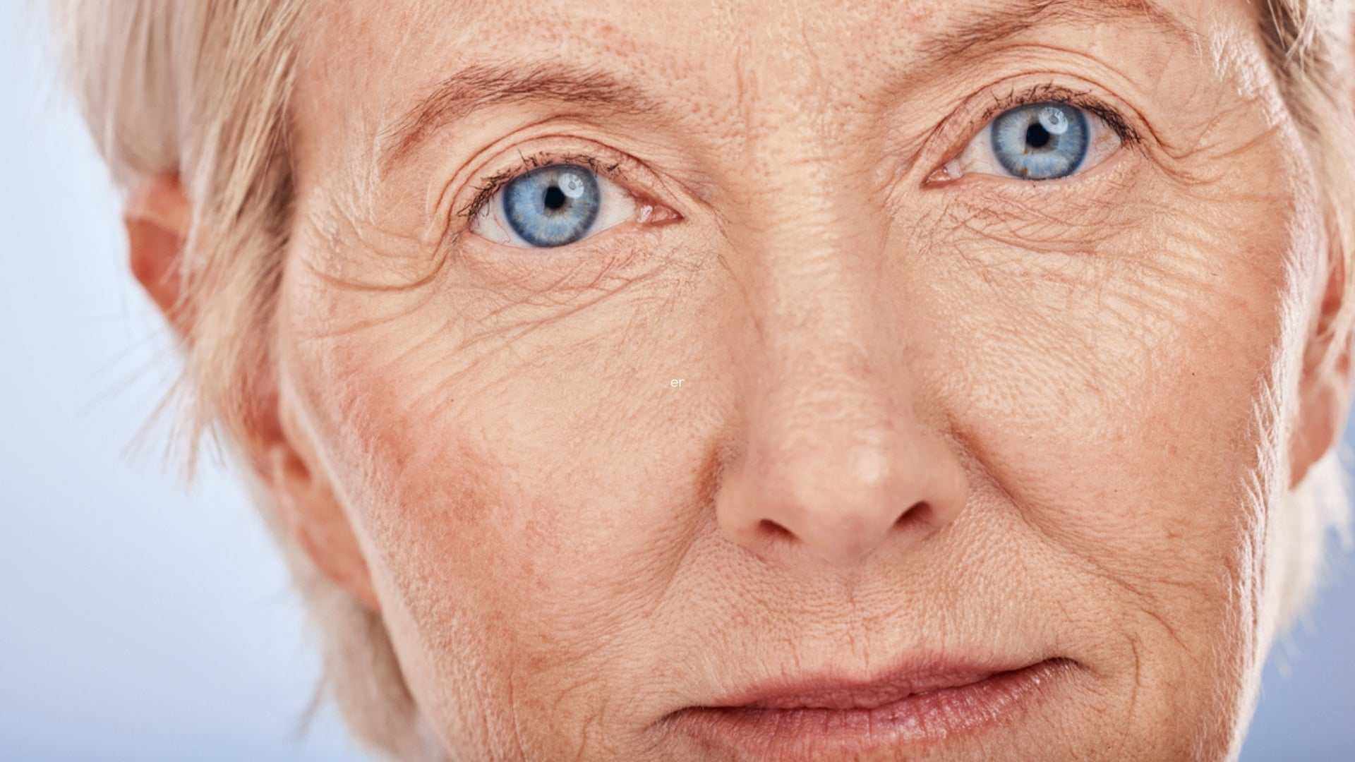 Alt Tag: The Aging Process and Your Skin close-up of older woman’s face showing fine lines, wrinkles, and dry skin texture
