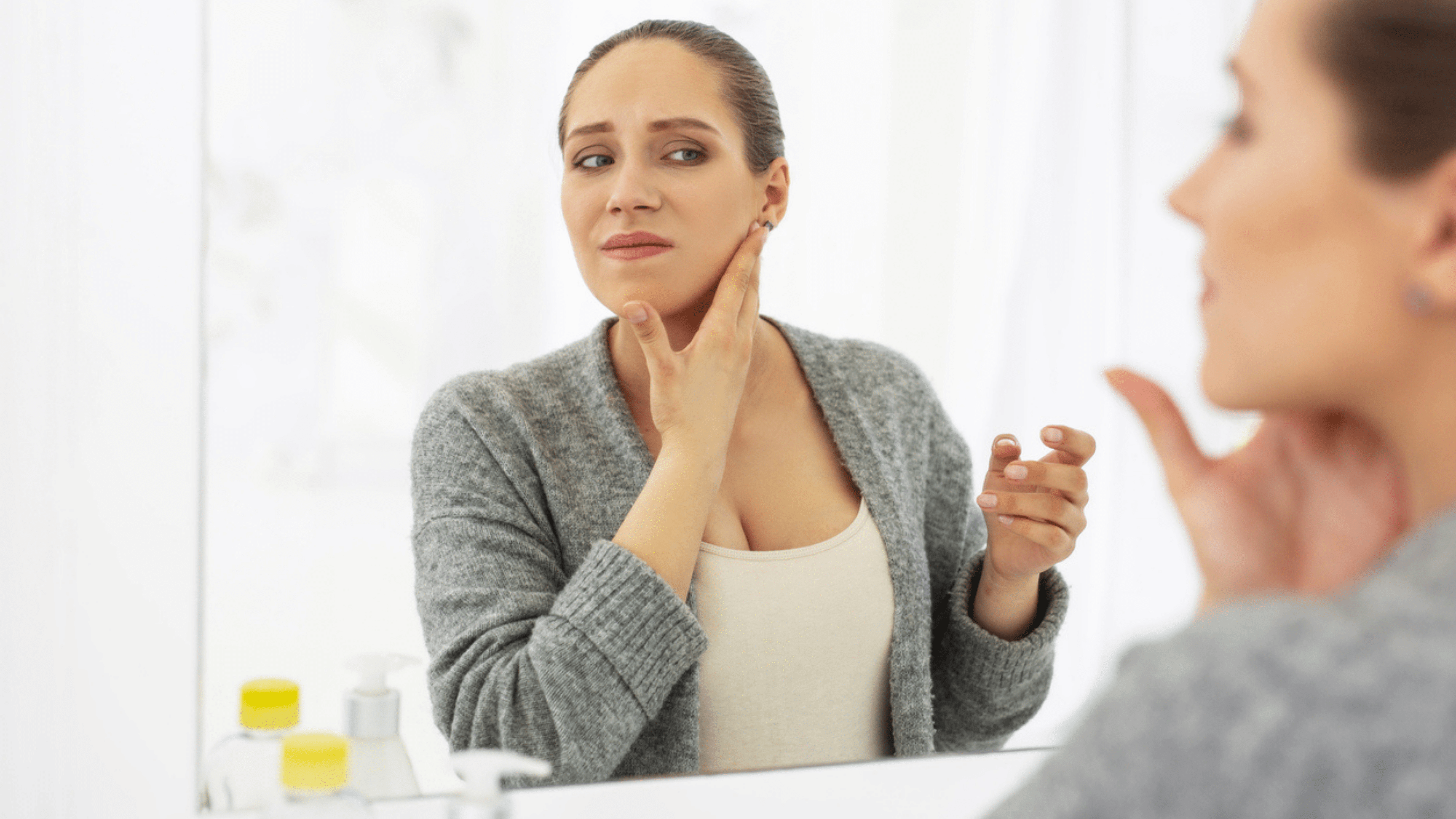 Alt Tag: Preventing Botox Mishaps: Expert Tips and Advice - woman checking face in mirror, concerned about botched botox complications