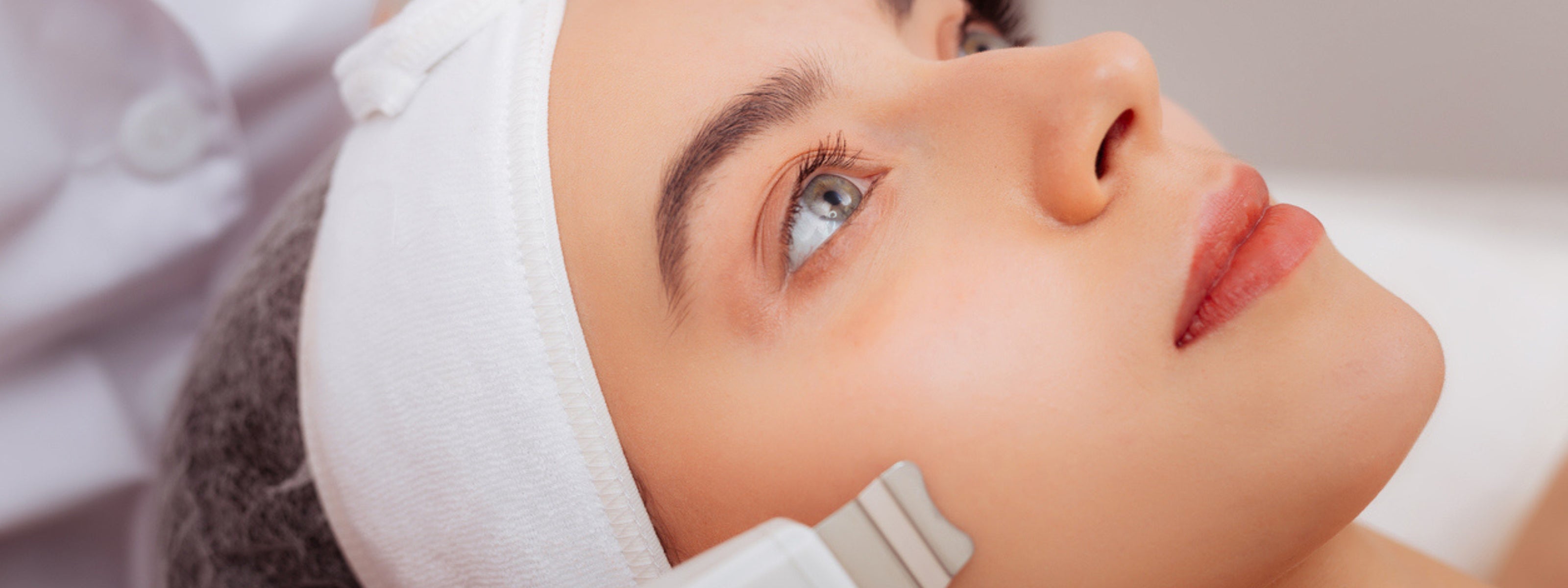 Woman lying on bed receiving fractional laser treatment