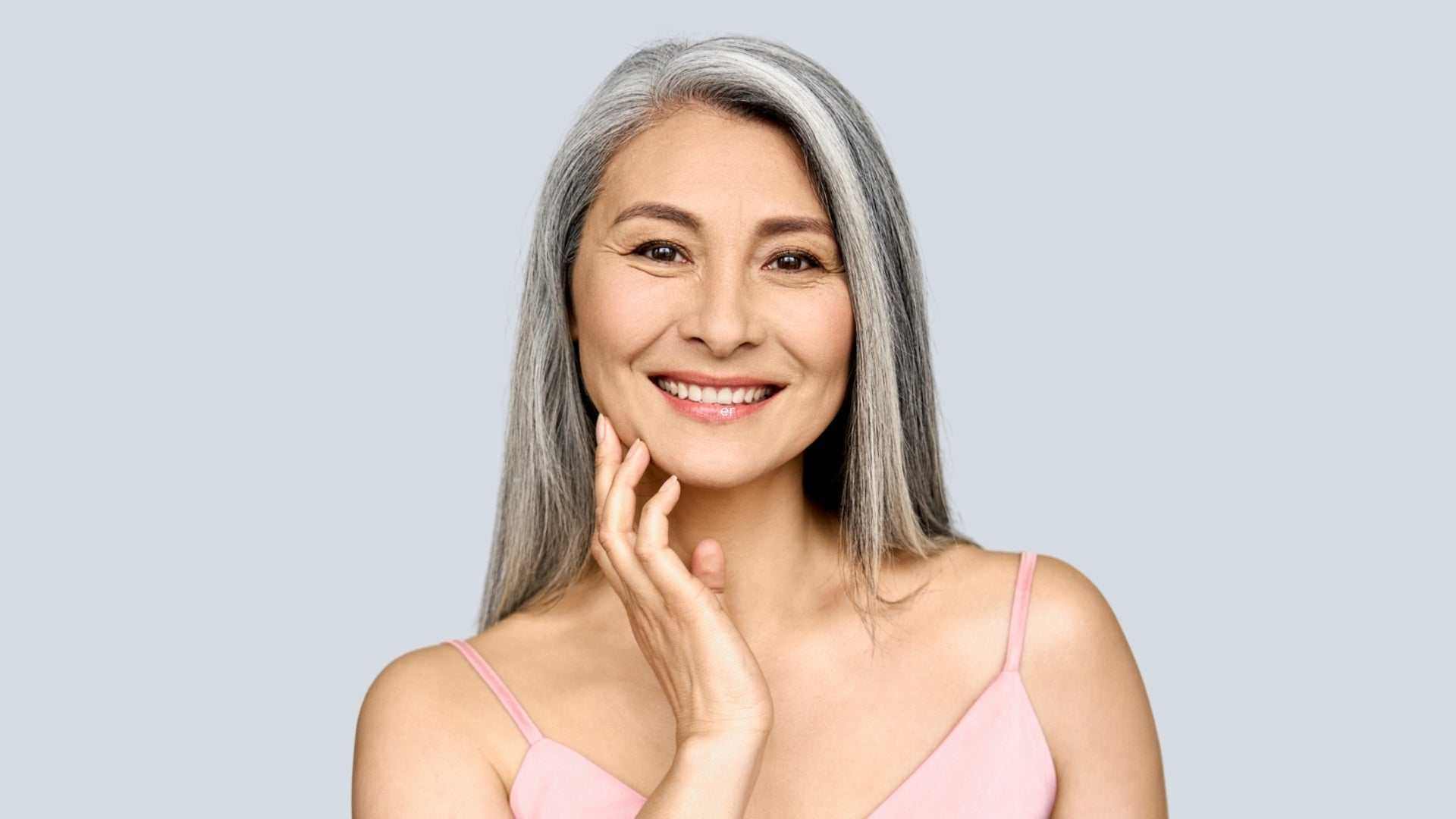 Woman examining loose skin after weight loss before skin tightening treatment consultation