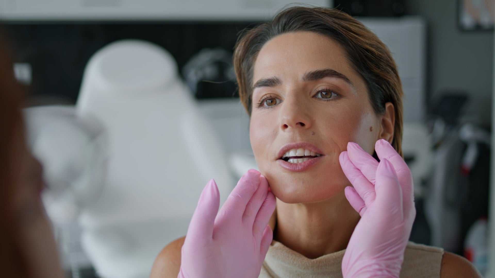 Woman consulting about masseter botox side effects in cosmetic clinic