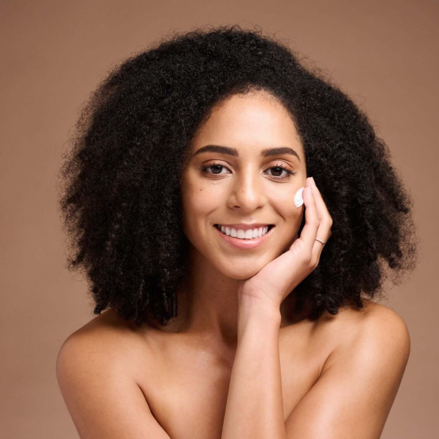 Sensitive Skin care model applying gentle moisturizer, calm barrier-support treatment for redness and reactive skin