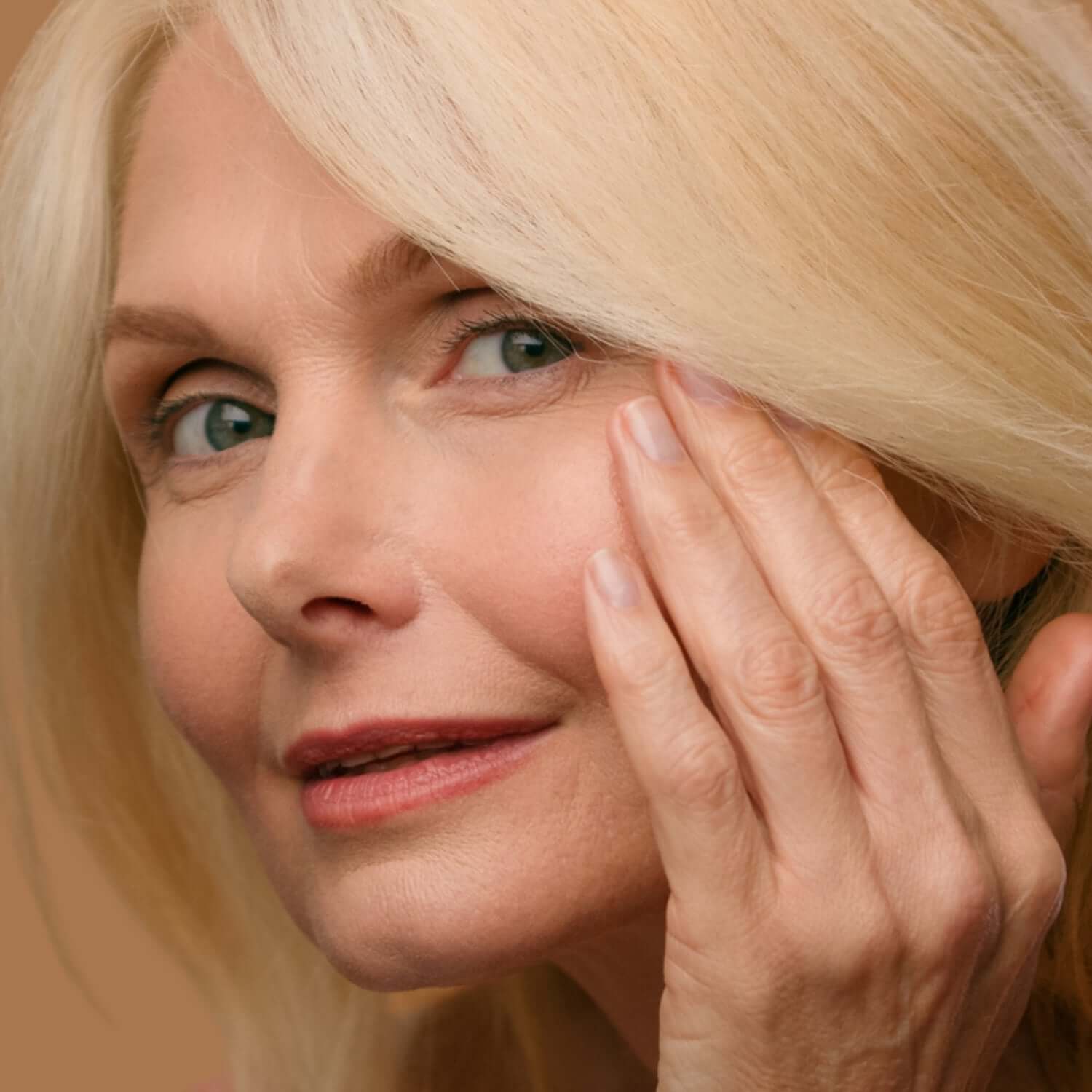 Alt Tag: Dry Skin hydrating facial treatment in Oakville, close-up of woman touching cheek to soothe tightness and restore moisture barrier