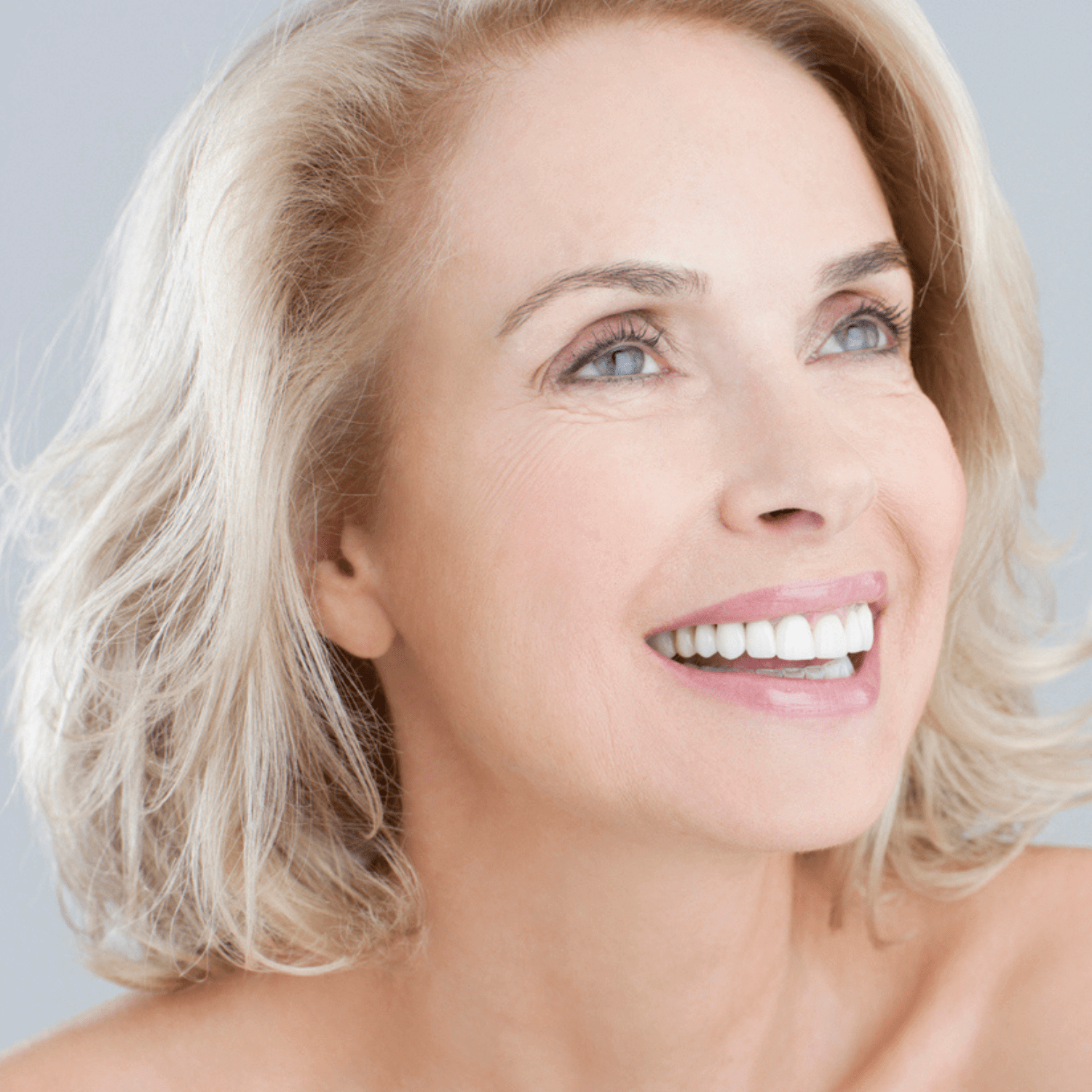 Regenerating skin treatment results in Oakville, smiling woman with refreshed complexion, improved texture, and collagen-boosted glow