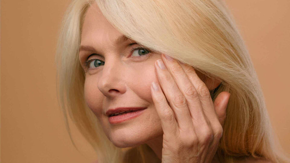 Biostimulation, Regeneration, And How To Build Your Own Collagen And Elastin   close-up of mature woman touching cheek, natural skin rejuvenation