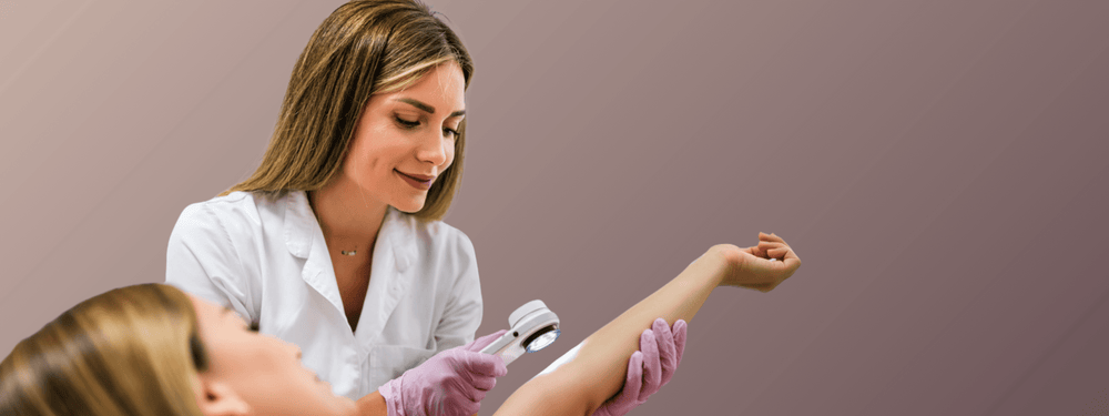 Common Skin Issues Treated by Oakville Derms - dermatologist examining patient’s arm in clinic consultation