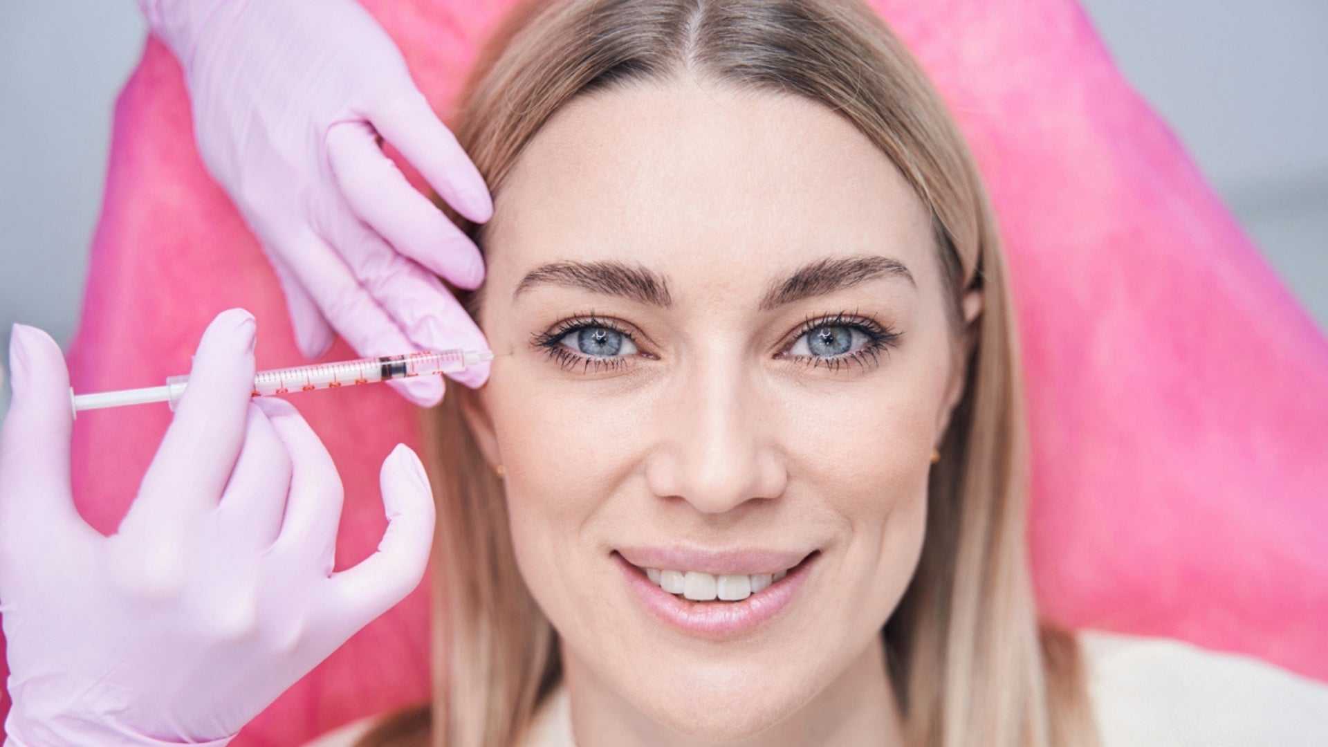Woman receiving Juvederm filler injection near the eyes, illustrating Juvederm filler cost and treatment in Canada.