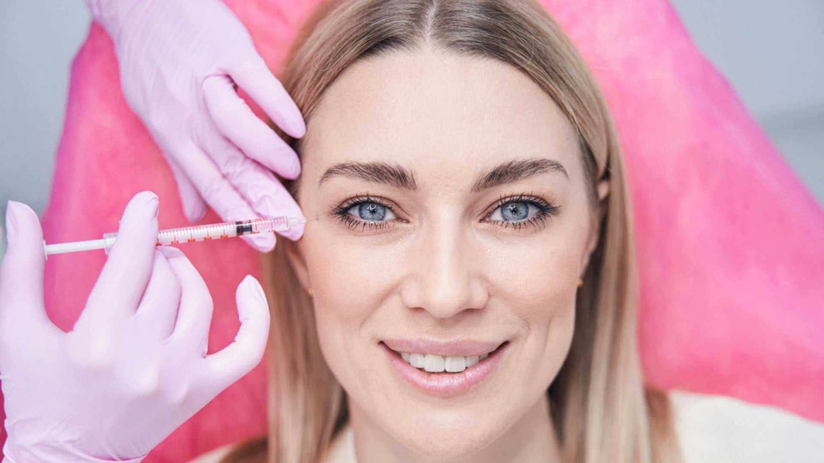Understanding Juvederm Filler Cost: What to Expect in Canada - clinician injects Juvederm dermal filler near woman’s cheek for facial rejuvenation