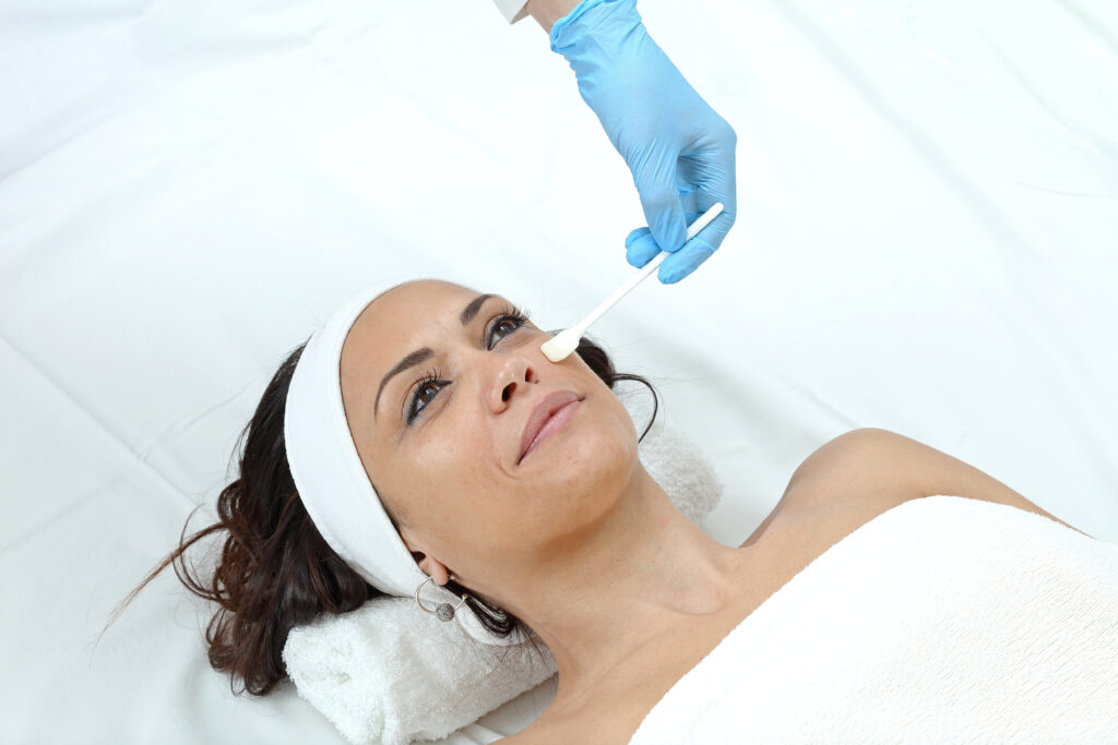 Woman preparing for dermal filler treatment